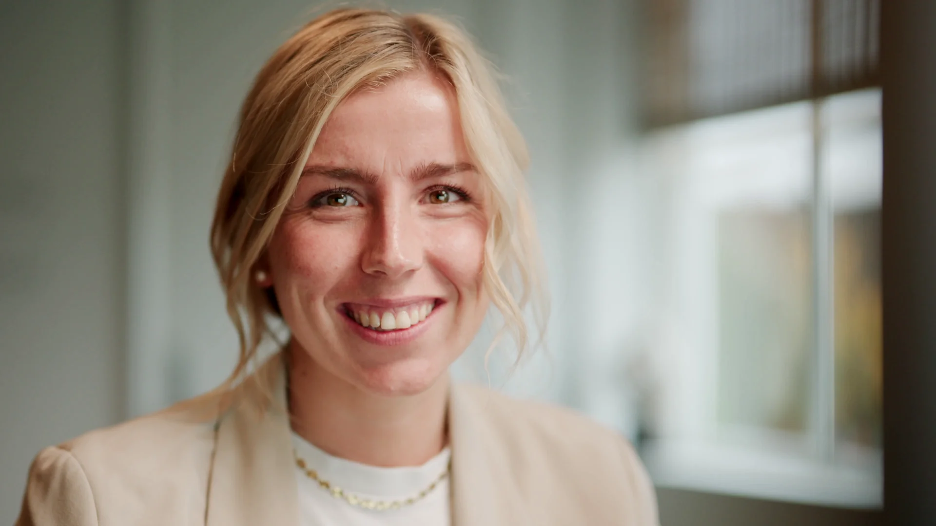 A Flowplan colleague smiling in a bright office